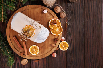 Christmas stollen on wooden background. Traditional Christmas festive pastry dessert. Stollen is present for Christmas. Top view