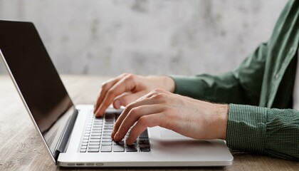 Focused on the Task: Hands actively typing on a laptop keyboard, showcasing concentration and productivity in a close-up shot.  The image suggests dedication and efficiency in the digital workspace. 