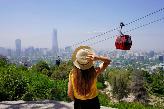 Visiting Santiago de Chile. Back view of tourist woman in Santiago Metropolitan Park with cable cars, Chile, South America.
