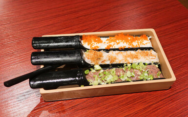 close up of minced squid, mutton and prawn shrimp paste ingredient on a black container ready for hot pot