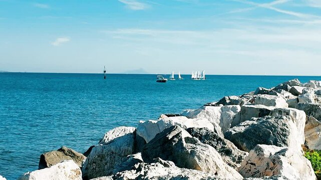 A serene view of a boat floating on calm waters in Anzio, Italy, captured in 4K resolution Perfect for travel, tourism, and maritime themes, showcasing tranquil seascapes a peaceful coastal enviroment