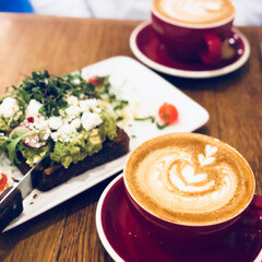 Latte in Red Cup with Avocado Toast at Cafe