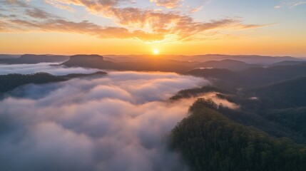 Fototapeta premium The sun rises over a tranquil landscape, illuminating mist-covered valleys and mountains while evoking a sense of peace and beauty. Generative AI