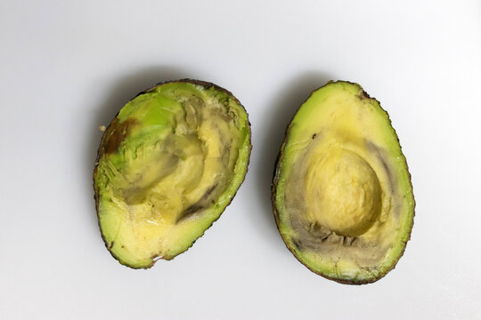 Avocados are rotten if they're mushy when squeezed, brown or moldy inside, and have developed rancidity or a sour smell.