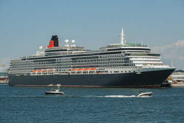 Luxury classic ocean liner cruiseship cruise ship Victoria in port of Helsinki, Finland with city skyline, marine traffic, archipelago island shores during summer Baltic cruising