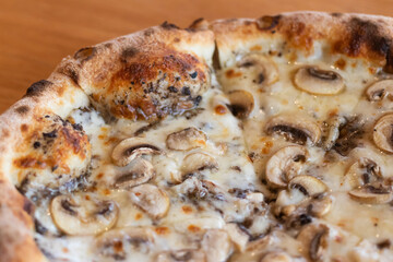 Pizza black truffle with cheese melting on plate.