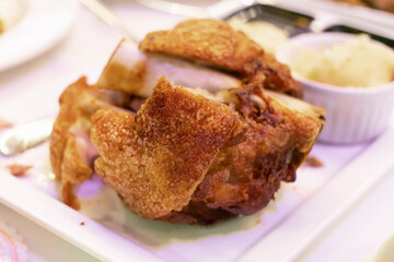 Deep fried crispy pork knuckle on plate.