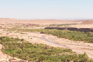 Desert River Landscape with Distant Mountains
