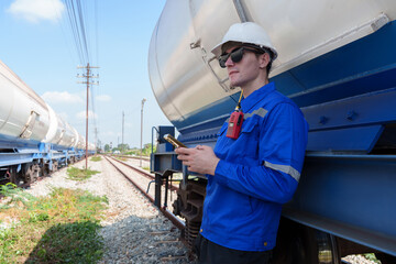 Male engineer checking the readiness of gas-powered train