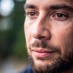 Fototapeta premium close up portrait of a young bearded man with a blue beard