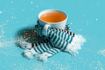 Mug of tea with warm scarves. Spring bad weather.