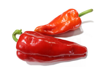 two red peppers are laying on a white surface.