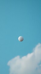White Tennis Ball Soaring Through Blue Sky