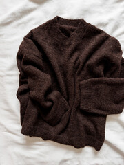 Brown fluffy cashmere sweater on a white background, top view