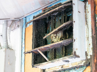 Neglected air vent cleaning abandoned building photo documentation urban decay close-up view health hazard awareness