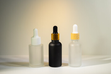 Minimalist amber glass dropper bottle for essential oils, skincare serums, or cosmetic products isolated on white background