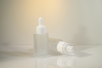 Minimalist amber glass dropper bottle for essential oils, skincare serums, or cosmetic products isolated on white background