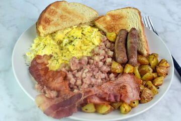 scramble eggs  with sausage, bacon and home fries