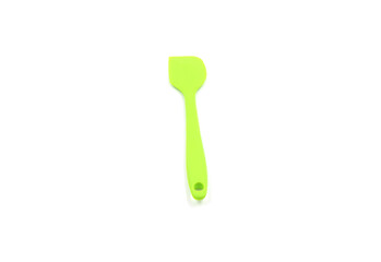 A Geen baking spatula on a white background