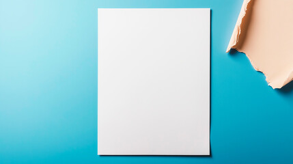 White paper sheet copy space on a blue background closeup mockup for designers. Minimalistic copyspace.