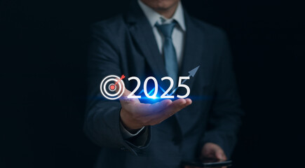 Goals and vision 2025, Business startup, target for success,Concept. Businessman's hand with 2025 text and dartboard icon Showing strategy for new year business plan