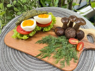 Spinach croissant bun with boiled egg and mushroom.
