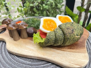 Spinach croissant bun with boiled egg and mushroom.