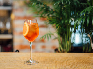 Aperol Spritz Cocktail with Orange Slice Garnish On The Bar Counter