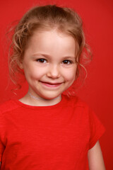 Close up little girl, isolated on red background studio