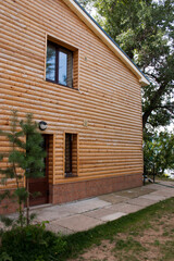 Wooden house in the yard of the house is made of logs