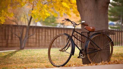 Naklejka premium Vintage Bicycle Leaned Against Tree Autumn Leaves
