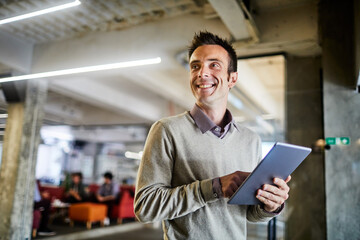 Young man using a digital tablet while working in a startup company office