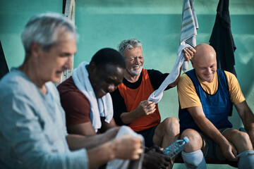 Senior men in the locker room tired after playing soccer