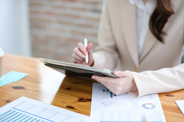 Close-up of a businesswoman using a tablet and stylus for work