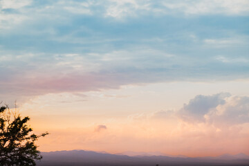 Landscape background of a cloudy sky in which the evening light produces beautiful and soft colors. The general appearance is that of a natural watercolor in a concept of relaxation and tranquility © LaMorenita