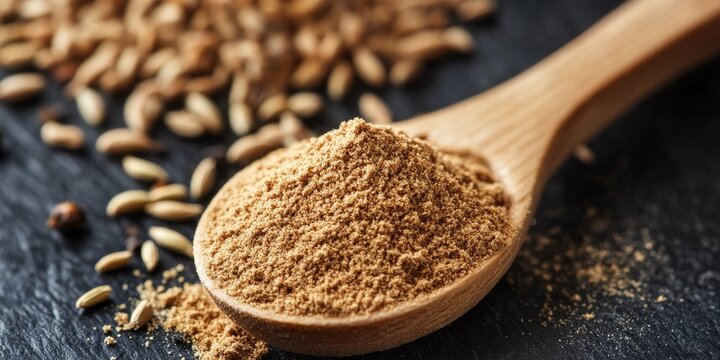 Ground cumin powder in a wooden spoon showcases the dried spice herb, commonly used in various cuisines and traditional medicine, highlighting the versatile nature of ground cumin.