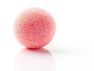 A pink, textured sphere on a reflective surface, suggesting a decorative or playful item.