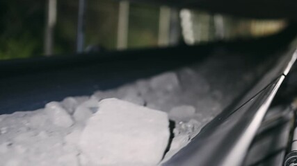 Nighttime conveyer belt in motion carrying ore in an industrial setting. Capture of a conveyer belt transporting ore at night, reflecting the bustling activity and vital role in the mining