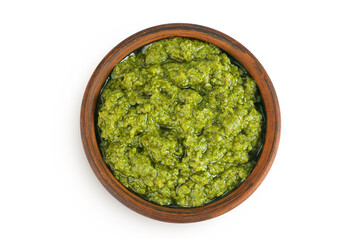 Pesto sauce in ceramic bowl isolated on white background. Top view. Flat lay