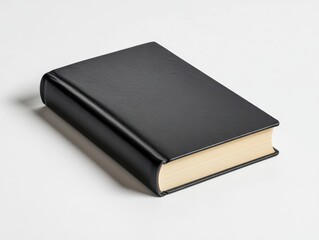 A closed black book with a smooth cover, symbolizing knowledge and literature.