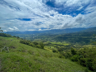 Fototapeta premium Beautiful natural landscape of the Poblanco river in southwestern Antioquia, Colombia with mountains in the background aerial view.