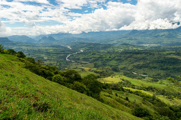 Naklejka premium Beautiful natural landscape of the Poblanco river in southwestern Antioquia, Colombia with mountains in the background aerial view.