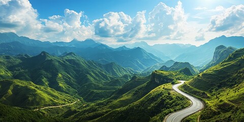 Scenic mountain landscape featuring a winding road on a mountain plateau, showcasing lush green mountains under a bright blue sky in this stunning visual of nature s beauty.