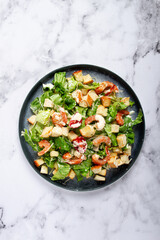 Caesar salad, with shrimp, on a marble background, top view, no people,