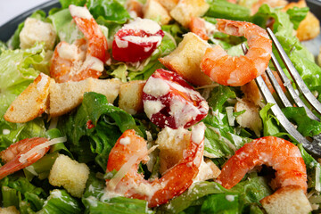 Caesar salad, with shrimp, on a marble background, top view, no people,