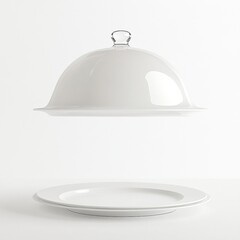 Fototapeta premium White serving cloche raised above empty white plate in a dining setting open serving cloche isolated on white a backgroun