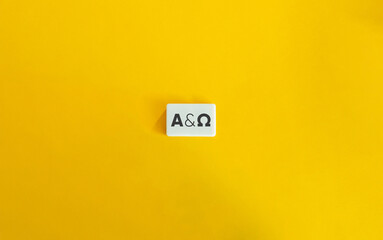 From Alpha to Omega Concept. Block Letter Tiles on Yellow Background