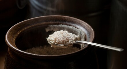 Steaming rice scoop rustic bowl in serene setting