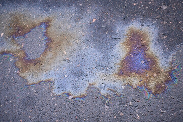 Multicolored oil stains on asphalt, mesmerizing artistic background.