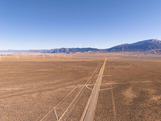 Aerial view of U.S. route 50, the loneliest road in the USA, and of a windmill park in interior...